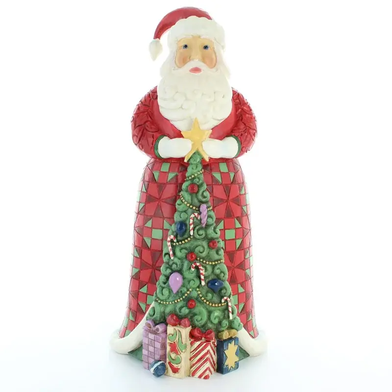 Statue du Père Noël tenant le sapin de Noël