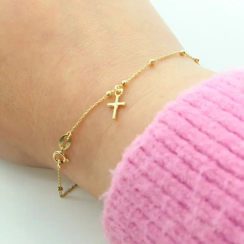 Bracelet dizainier en or 18 carats avec croix pendante