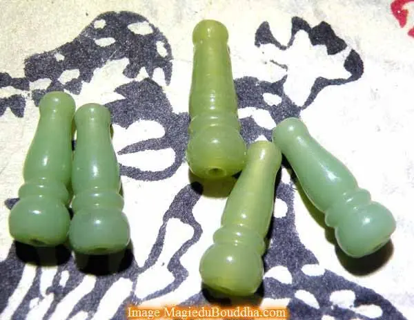 Head bead for Tibetan mala in jade-colored glass.