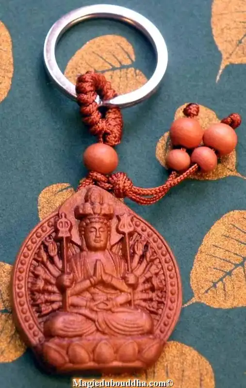 Buddha and Guan Yin key rings in carved wood.