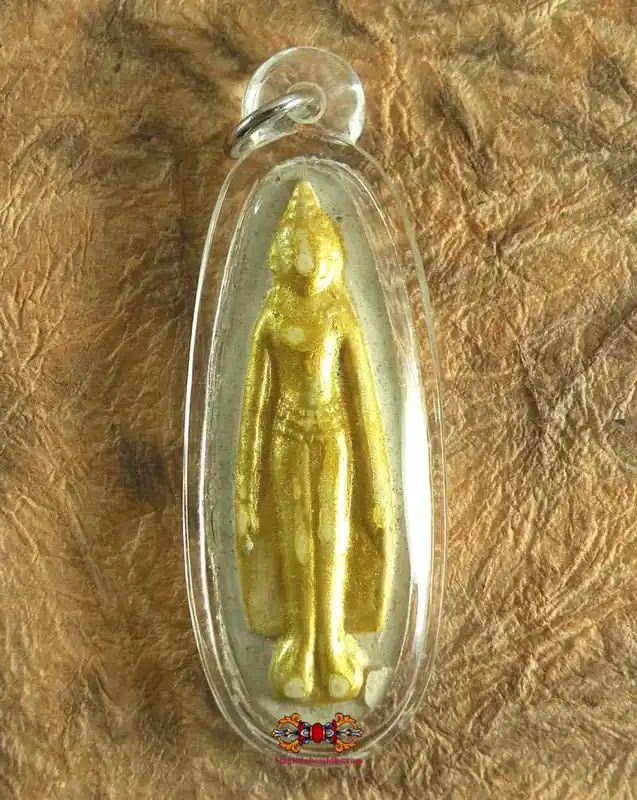 Golden amulet of the standing Buddha