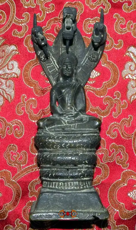 Beautiful ancient statue of the Buddha under the King of the Nagas.