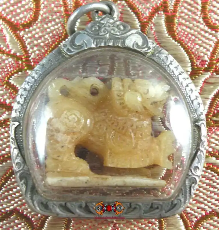 Antique Singharaj bone amulet with silver reliquary.