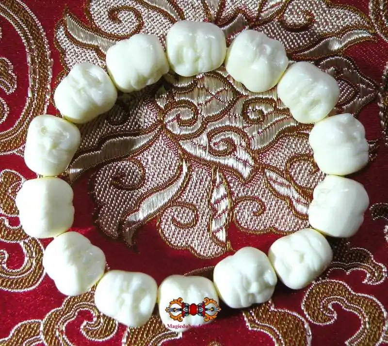 "Face of the Buddha" wrist mala in ivory-colored resin.