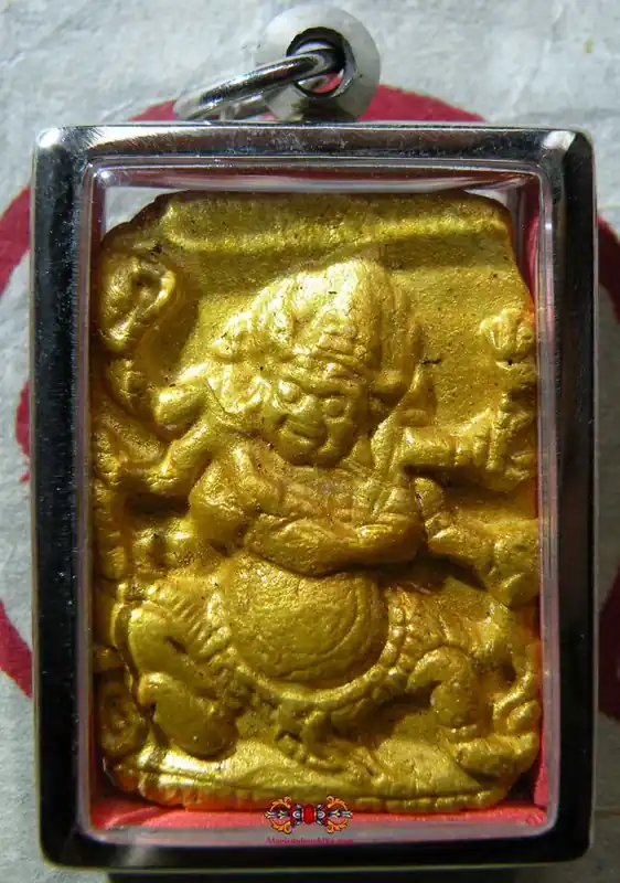 Tibetan Tsa Tsa amulet, golden, of a white Mahakala with 6 arms.