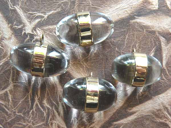 Tibetan "glacier crystal" Shiva Lingam pendants.