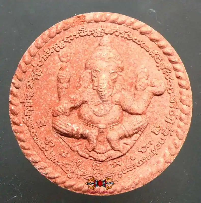 Large red amulet of Ganesh and Brahma.