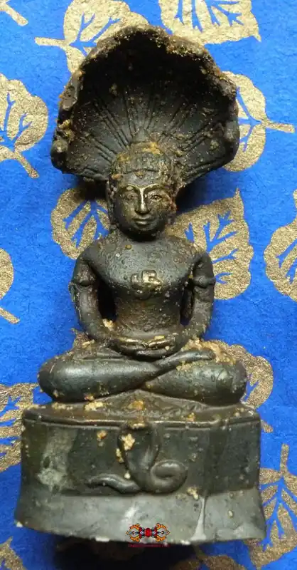 Blessed statue of Buddha under the King of Nagas - Wat Kruha Suwan.