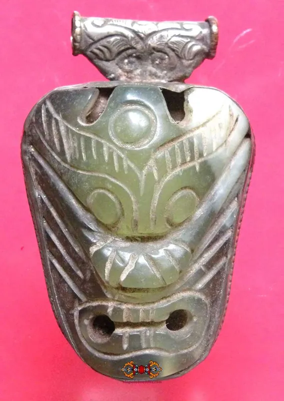 Large Nepalese jade demon mask pendant.