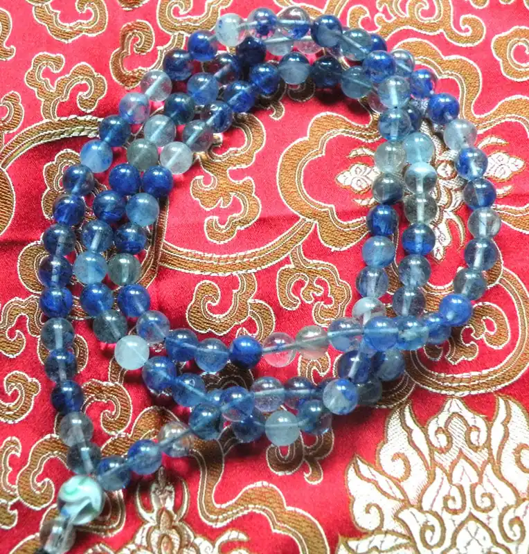 Large Buddhist rosary in blue marbled glass.