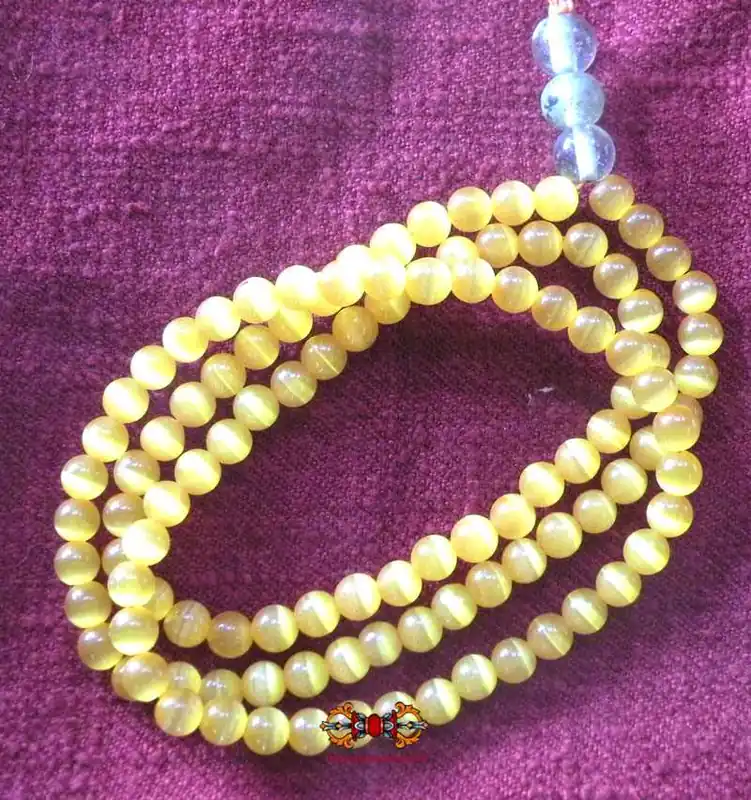 Buddhist rosary made of opalescent orange glass beads.