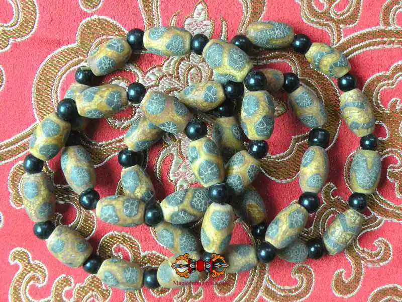 Tibetan bracelet of small, various patinated Dzi.