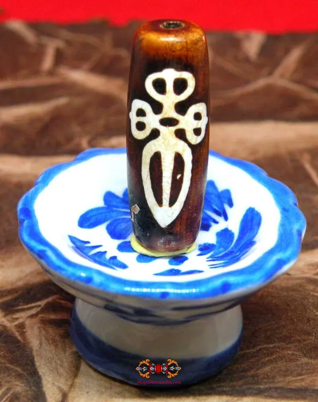 Sacred Tibetan Dzi bead decorated with a Phurba - Blessing of Vajrakilaya.
