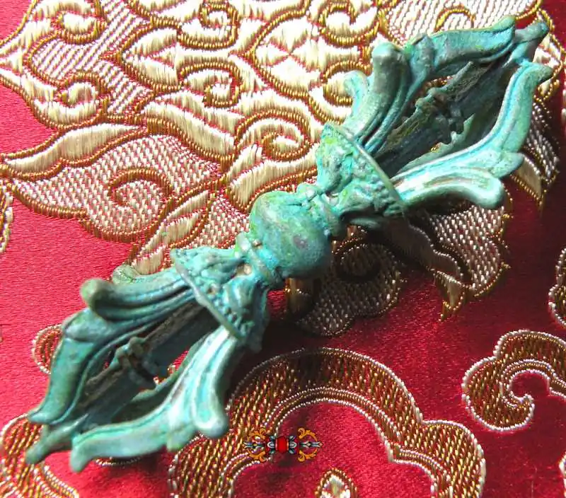 Tibetan Vajra in patinated bronze.