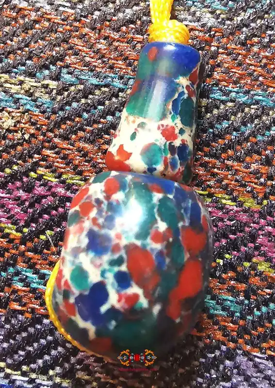 Tibetan rosary head bead - in multi-colored resin.