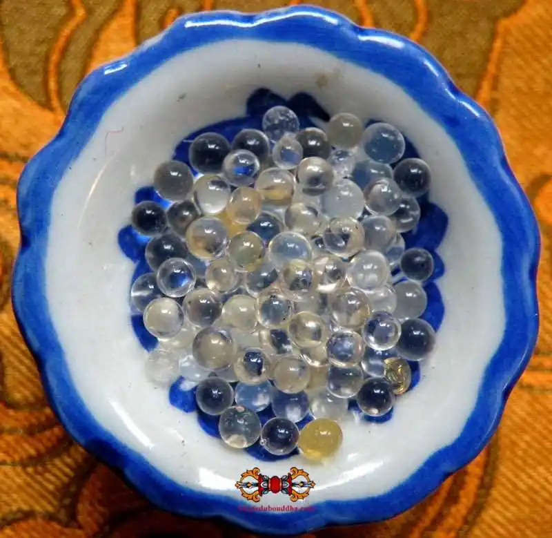 Buddhist relic sacred beads Ringsel translucent in a sealed reliquary.