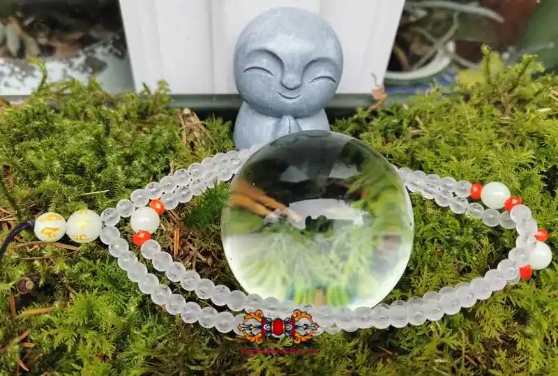 Tibetan Buddhist crystal rosary adorned with mantra and fluorescent Chinese Ye Ming Zhu stone beads.