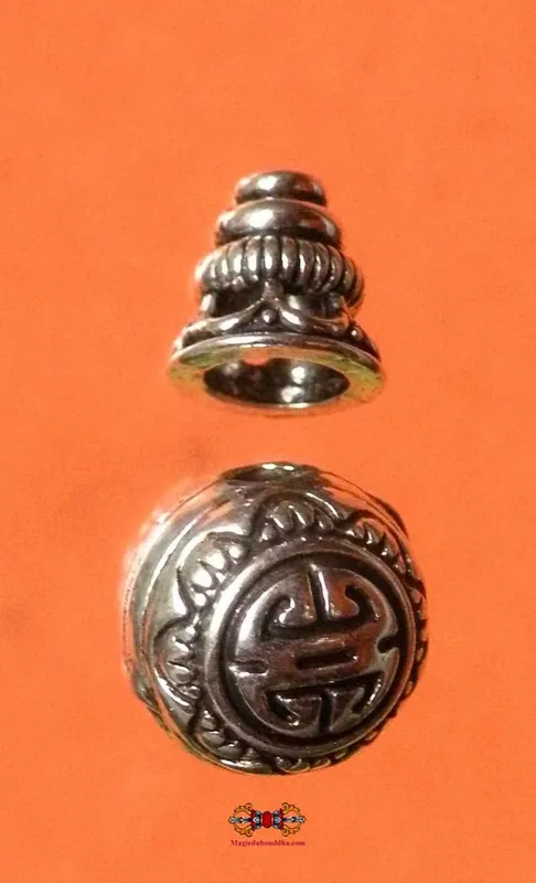 Head bead for Tibetan Buddhist rosary in silver-colored metal.
