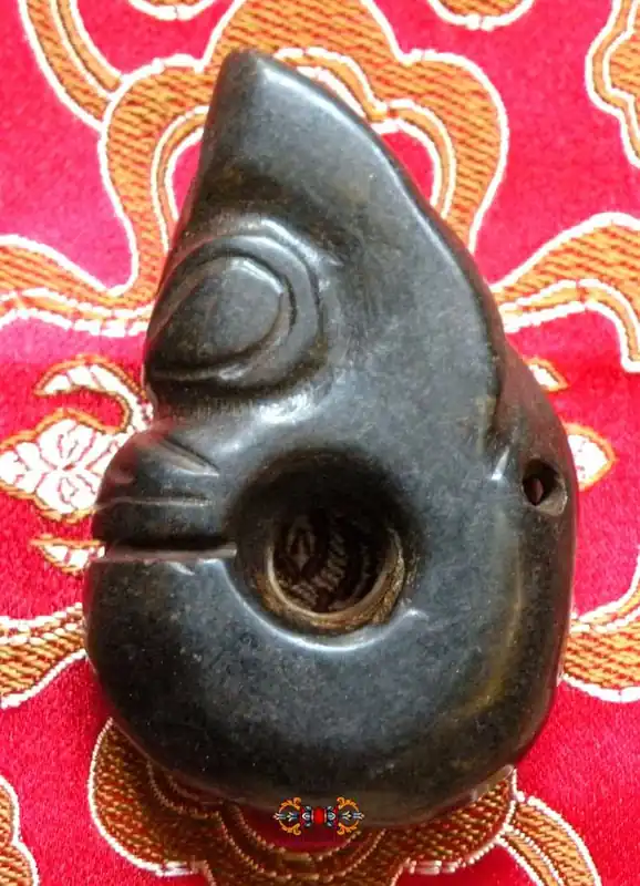 Large Tibetan tokchag amulet in the shape of a dragon's head.