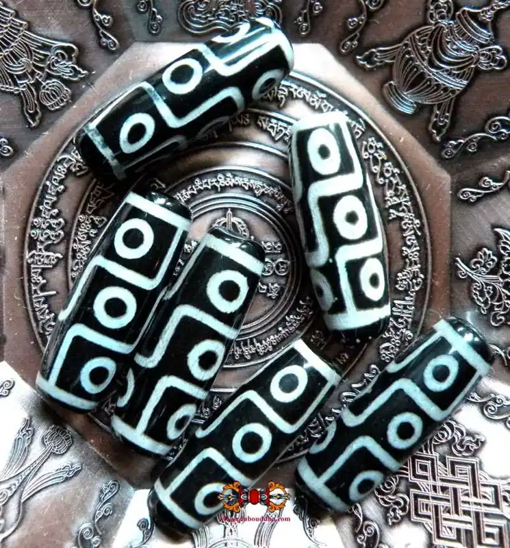 Small black Tibetan Dzi with 9 eyes.
