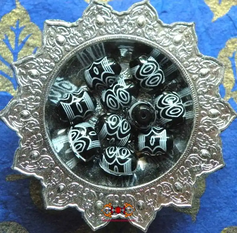 Small sacred Tibetan Dzi beads with 6 black eyes.