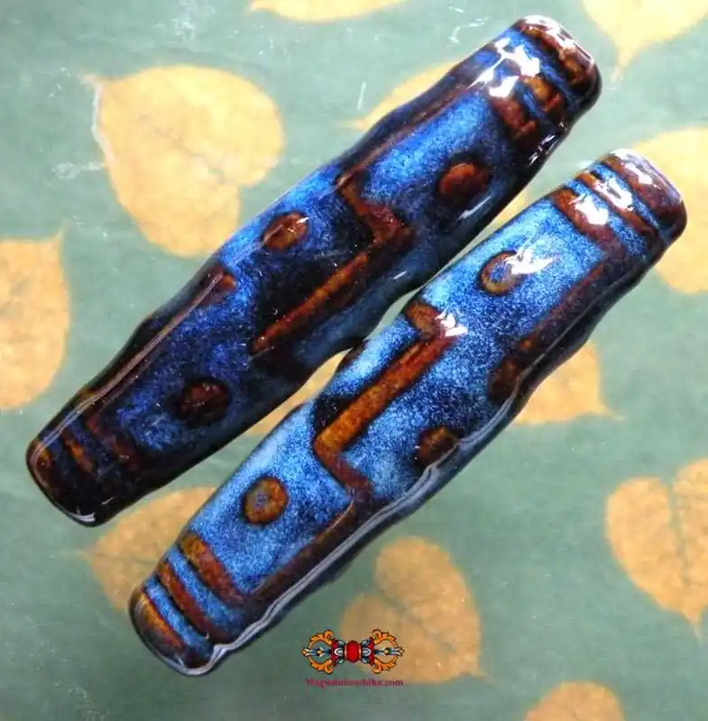 Pair of large Tibetan dark blue and brown ceramic Dzi style beads.