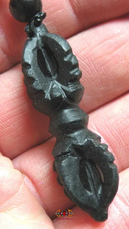 Dorje pendant made of carved magnetic stone.