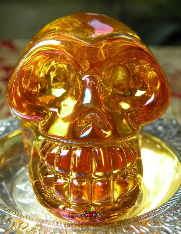 Human skull in orange glass.