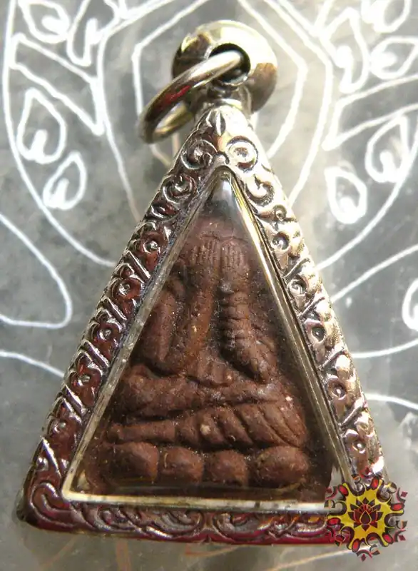 Small triangular Thai Phra Pidta amulet.