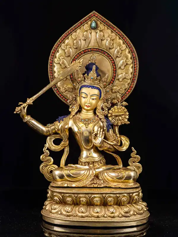 Statue en cuivre de Manjushri avec un visage en or brûlé
